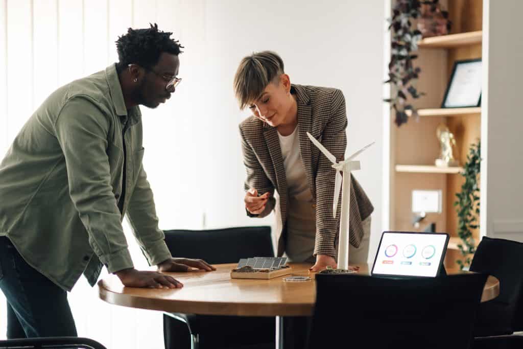 Two professionals discussing renewable energy solutions at a round table.