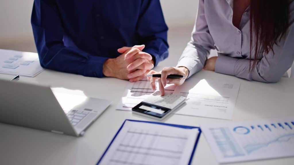 Forensic accountants reviewing financial documents for litigation support.