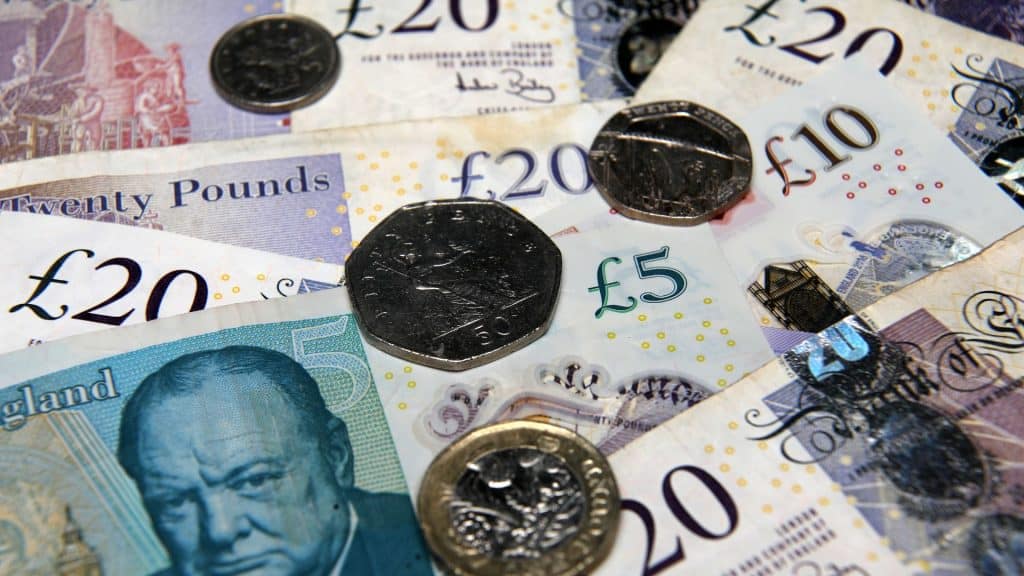 Financial documents and British currency notes and coins.