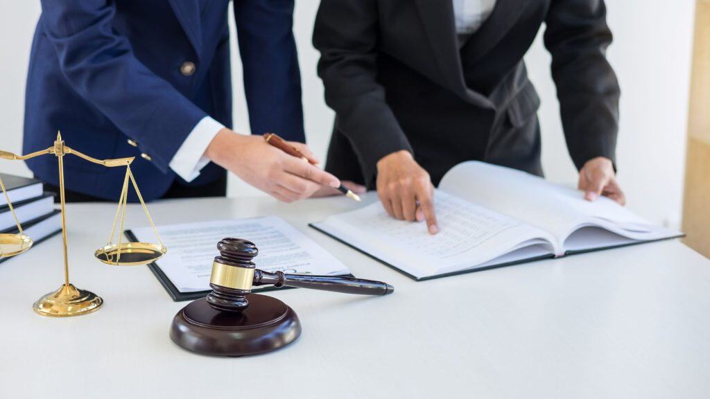 Forensic accountants reviewing financial documents for fraud cases.