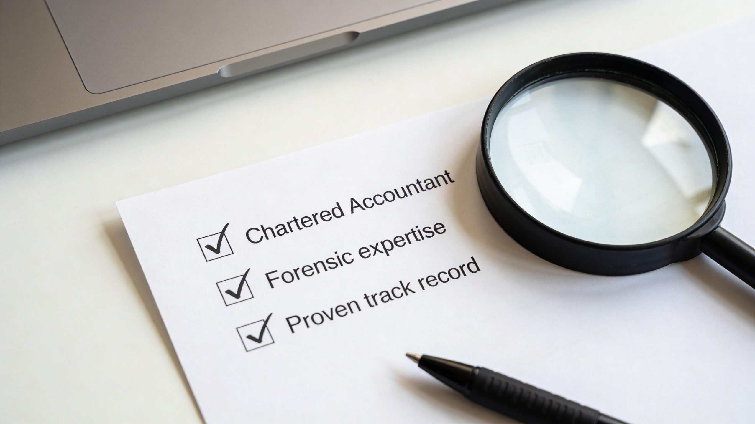 A checklist featuring criteria for professional services with a magnifying glass and pen on a desk.