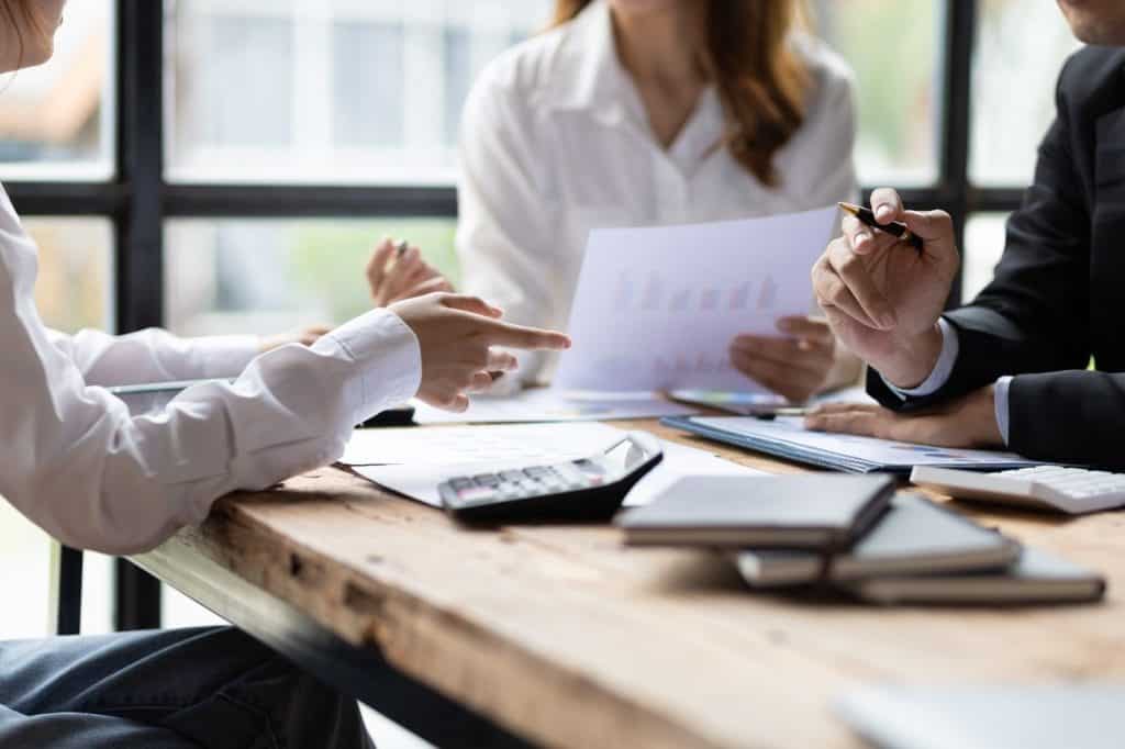 Colleagues reviewing documents together at a meeting table